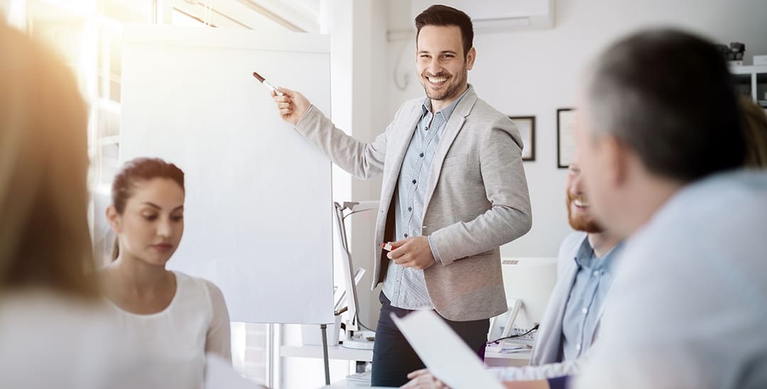 Professionals participate in a leadership development workshop around a conference table.